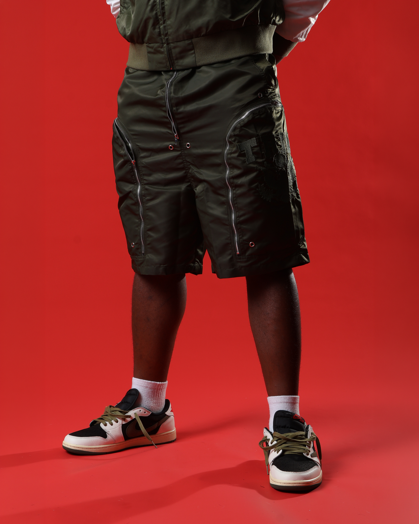 Green triple zip shorts
